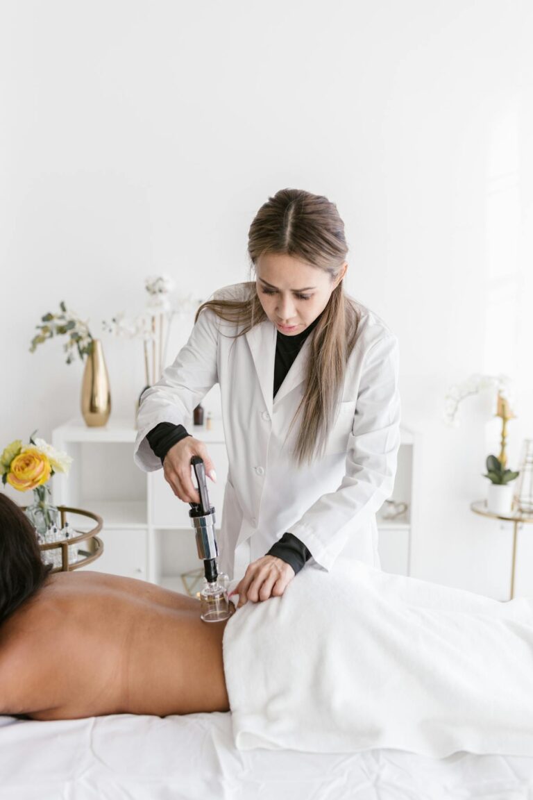 A therapist performs cupping therapy on a client in a modern spa setting.